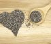 heart symbol made of black chia seeds and spoon
