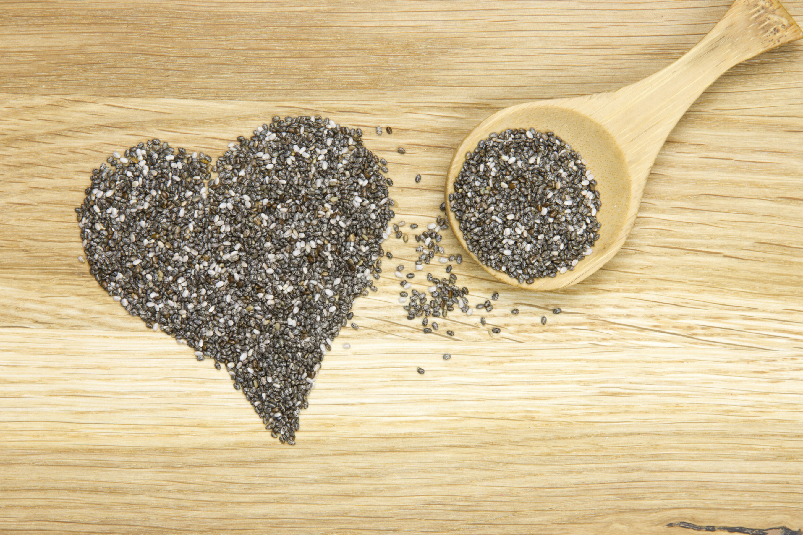 heart symbol made of black chia seeds and spoon